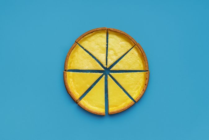 Homemade cheesecake top view, minimalist on a blue background