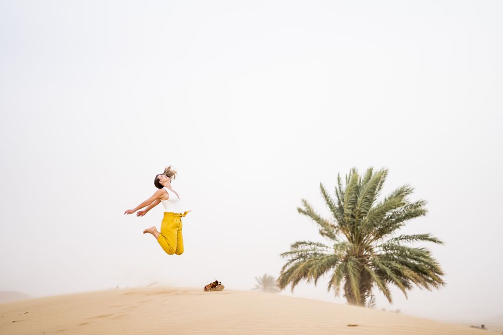 Happy woman jumping in desert