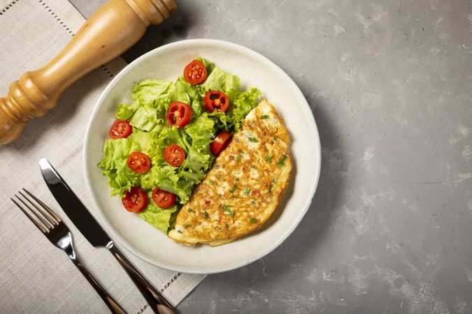 Omelet with cheese and lettuce and tomato salad.
