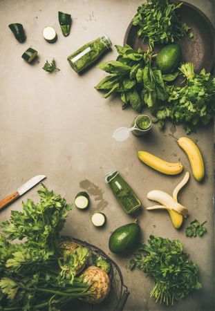 Smoothie ingredients, avocado, banana, zucchini, artfully arranged on grey table, with copy space