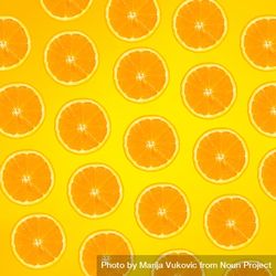 Pattern of orange slices on yellow background 5arD84