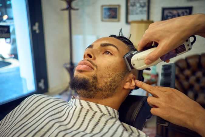 Anonymous hairstylist doing a haircut