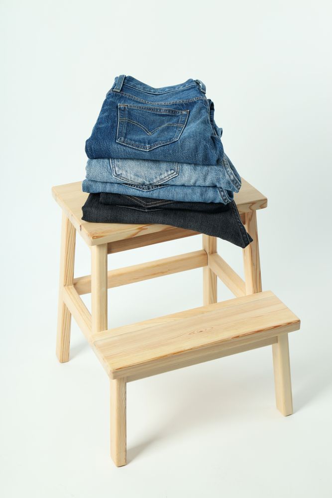 Folded jeans on a wooden chair
