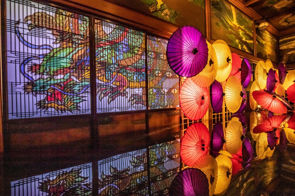 Japanese style hallway decorated with colorful oil-paper umbrellas and dragon painting on window