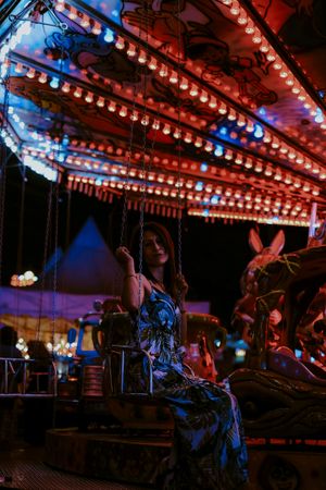 Woman enjoying ride on carousel