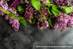 Spring floral card concept with lilac flowers framing concrete counter 4BavdX