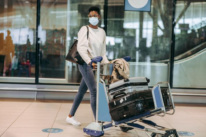 Black woman in face mask at airport
