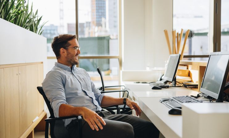Entrepreneur sitting relaxed at desk in office