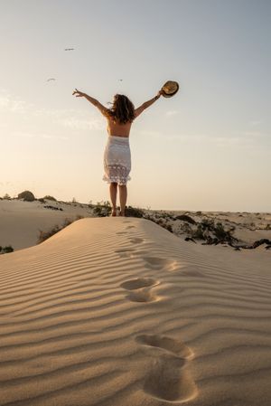 Active woman walking in dry desert barefoot