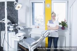 Smiling blond dentist in her bright office 5zpAQb