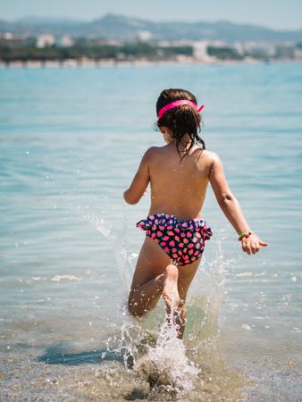 Cheerful girl having fun in warm sea