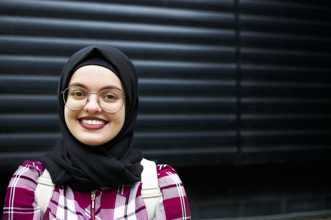 Happy woman in hijab and glasses