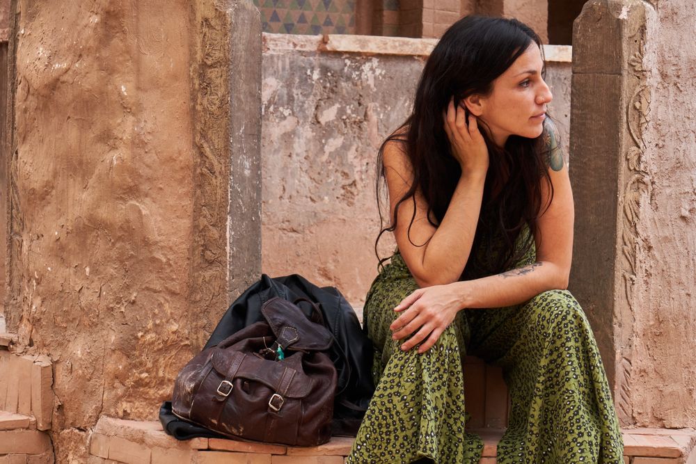 Woman on street between ancient buildings