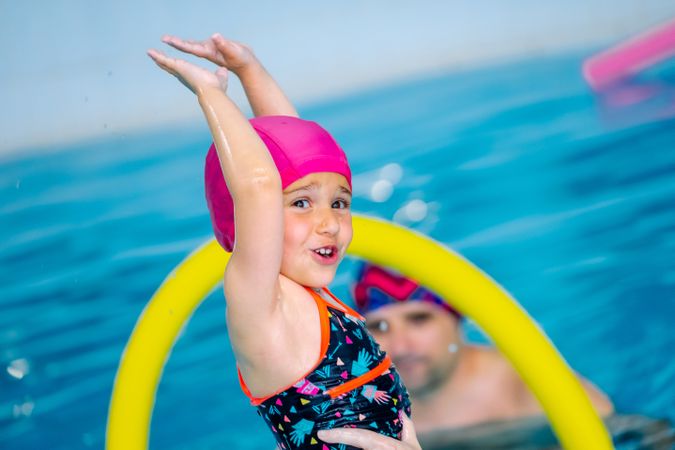 Mother playing with daughter in swimming pool