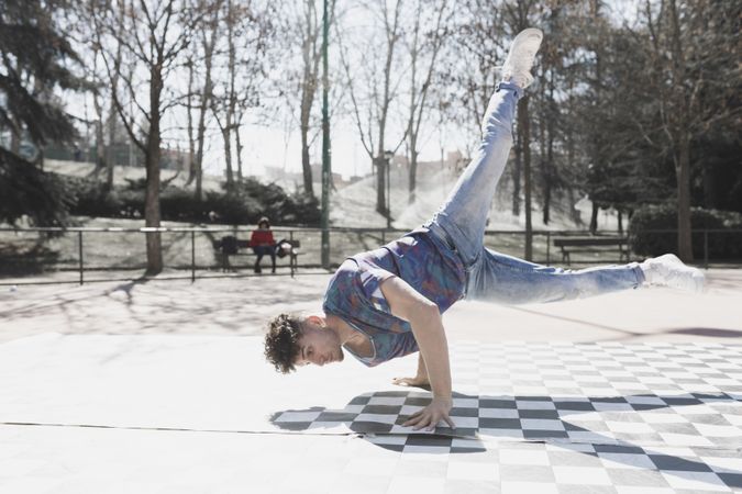 Man dancing break dance in park