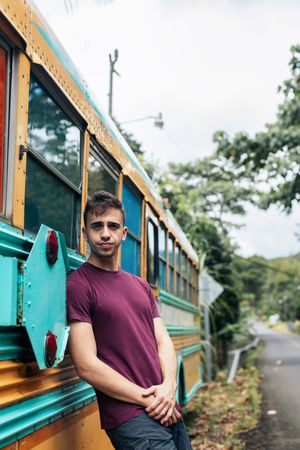 Man leaning on a vintage school bus