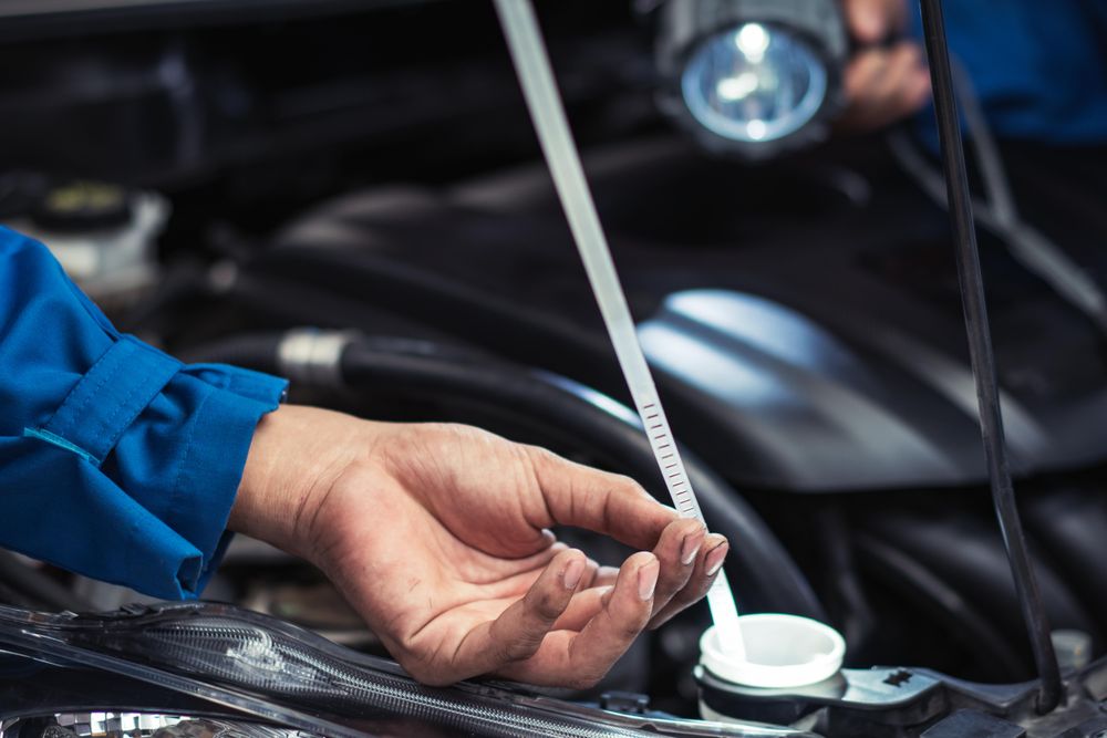 Close up of man checking oil level
