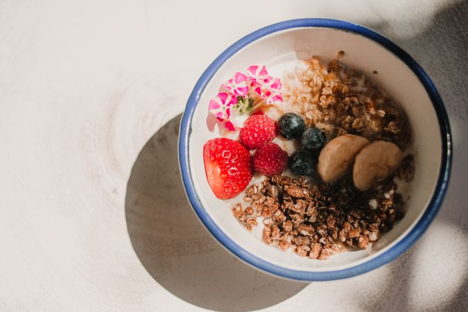 Ripe red strawberry blueberry and cereals in bowl