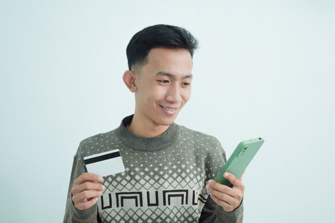 Businessman wear suit with t-shirt with blank credit card in studio shoot