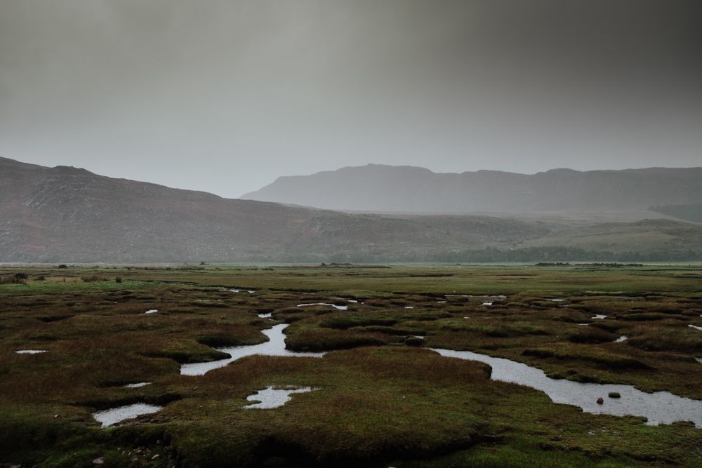 Valley covered with water patches surrounded by hills
