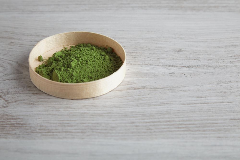 Matcha tea powder displayed in round box