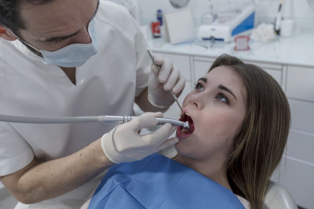 Portrait of a dentist and a young patient in the dentist clinic