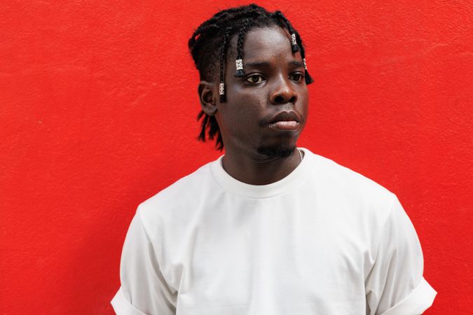 Man with unique hair, Standing at red background