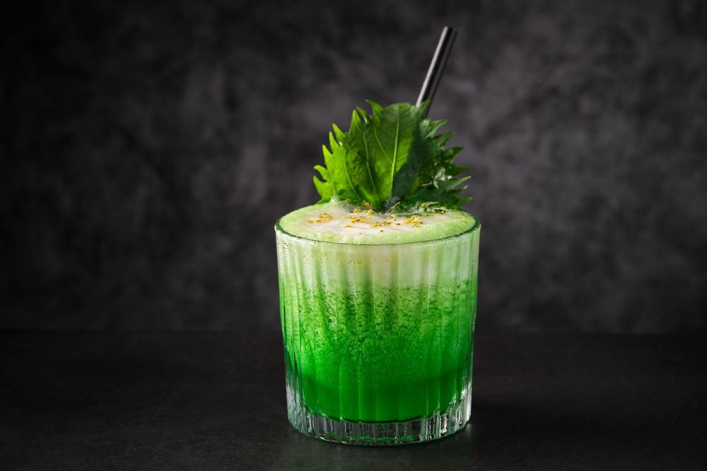 Delicious green cocktail with foam decorated with shiso leaf