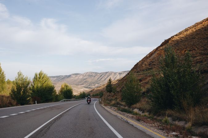 Motorcyclist through mountainous terrain
