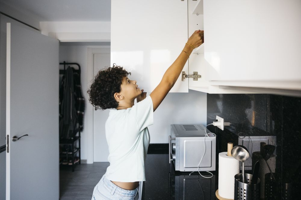 Girl preaparing a cup of milk
