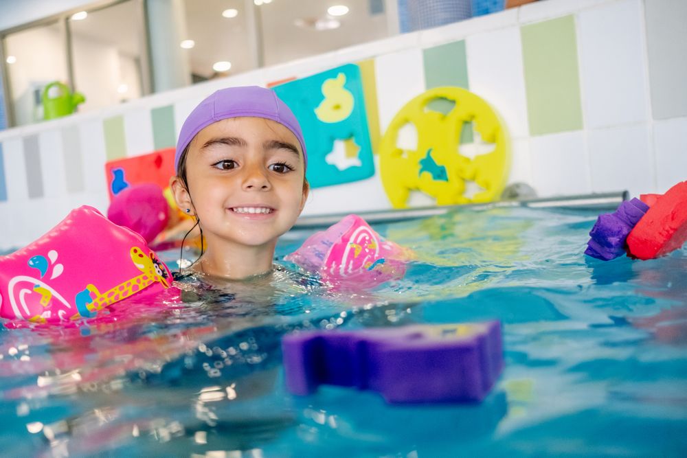 girl with water wings in swimming pool