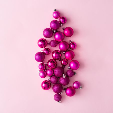 Arrangement of pink festive baubles on pink background
