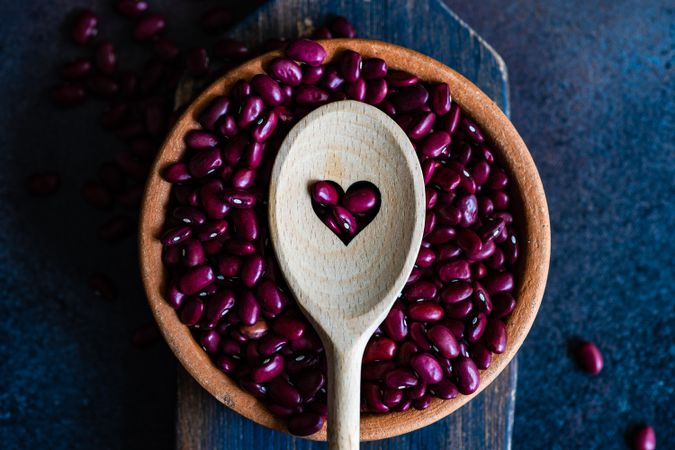 Bowl of kidney beans with wooden spoon with heart
