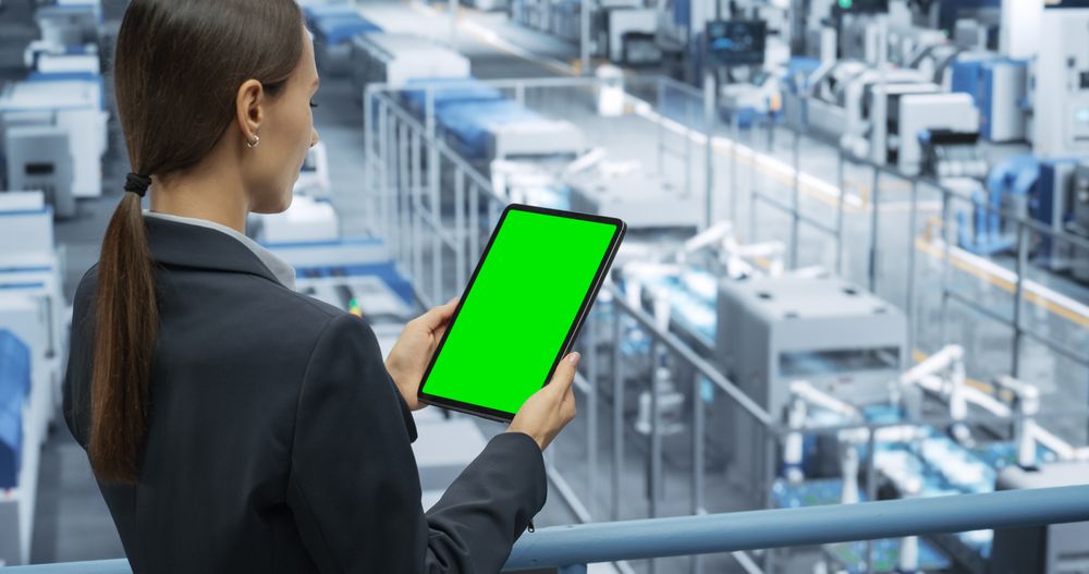 Electronics Manufacturing Project Manager Working on a Tablet Computer with Green Screen Template at a Factory. Female Specialist Developing, Maintaining, Upgrading Programs for Machine Production