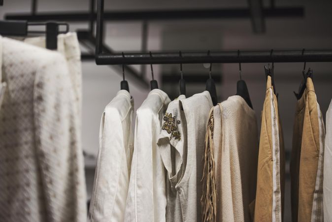 Clothes rack of brown and beige women's outfits in fashion store