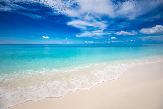 Clear tropical water coming up onto a sandy beach