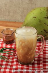 Side view of Indonesian coconut drink on red tablecloth 4OvYL5