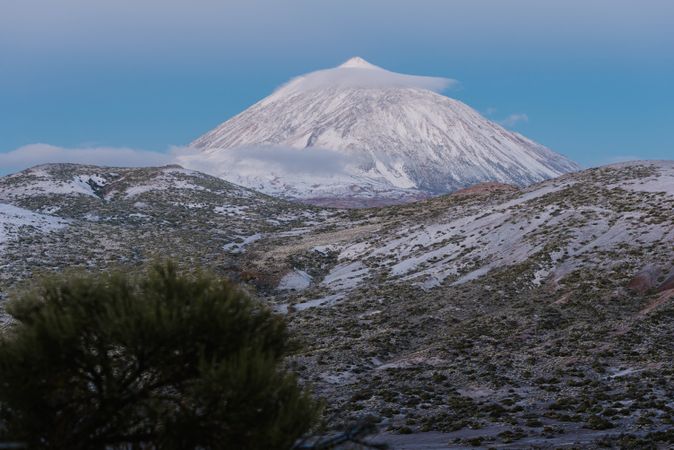 Clouds near snowy mountain