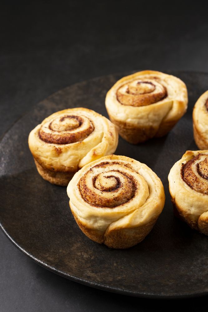 Cinnamon rolls on dark background.