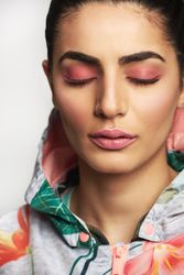 Portrait of woman with pink eyeshadow wearing floral hoodie