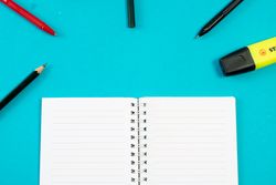 Open notebook with writing tools or school equipment