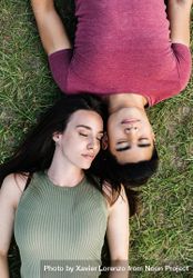 Looking down and young man and woman lying on the grass 0WqmO4