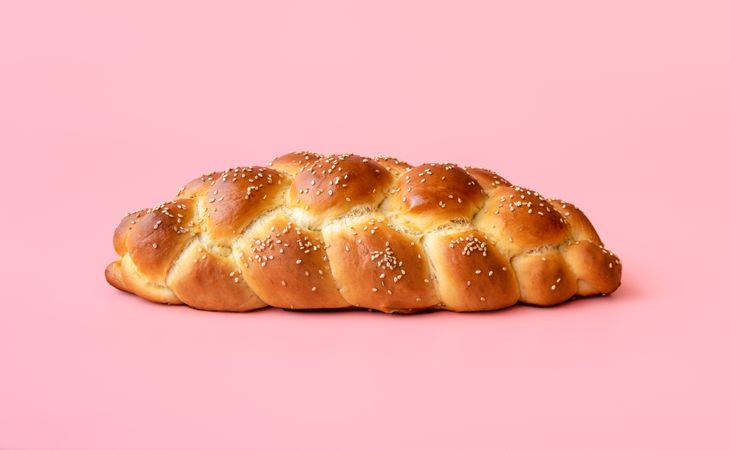 Braided bread isolated on a pink background