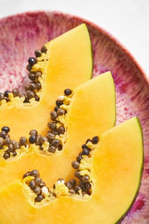 Fresh slices of papaya on plate