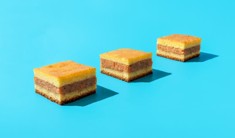 Apple pie slices isolated on a blue background