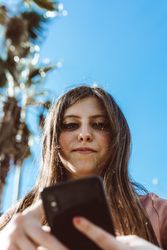 Teen girl looking at her smartphone.