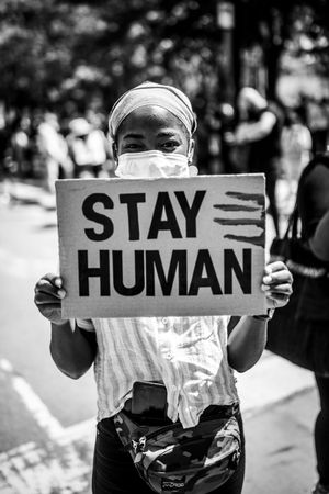 MONTREAL, QUEBEC, CANADA – June 7 2020- Woman holding “stay human” sign at protest