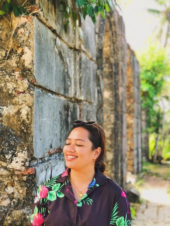 Portrait of smiling woman in floral top standing outdoor