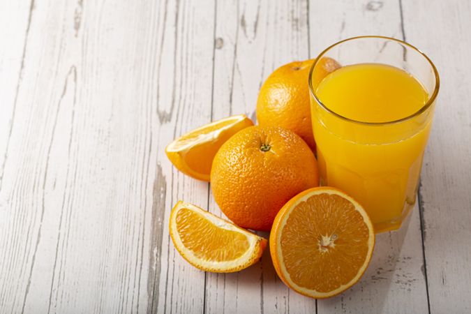 Glass with orange juice on the table.