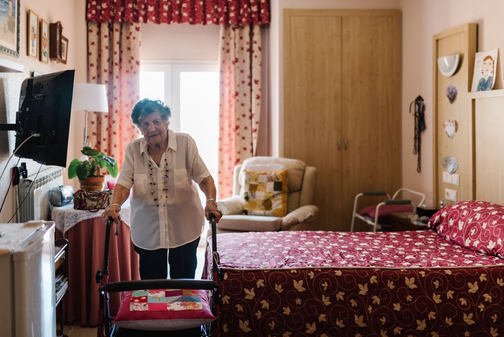 Mature woman with walker on bedroom